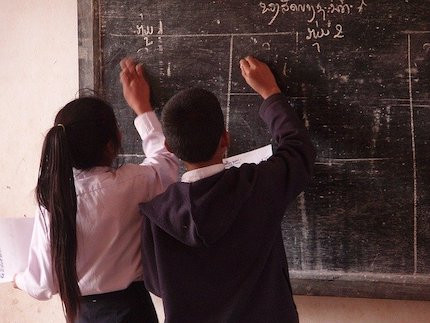 Children writing on chalkboard