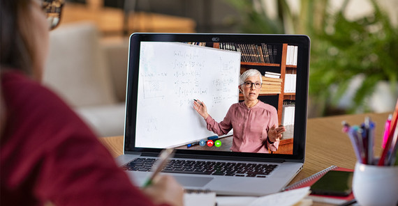 Person in front of a laptop with zoom meeting. Photo is from AdobeStock/Rido.