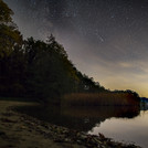 Stars and comet over the lake.