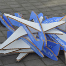 Blue and white cardboard planes lying on the floor with the phrase 'shrink aviation'