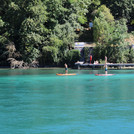 People canoeing and swimming at the Rhone near Genf, view to riverbank