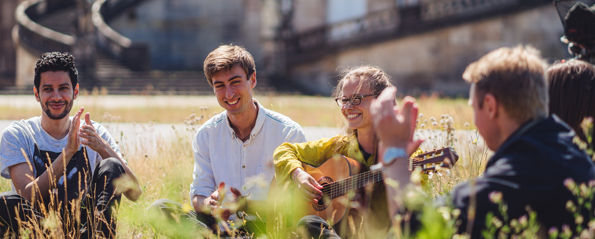 students sitting on campus - Programs