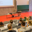 This image shows students in a full lecture hall. 