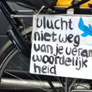 A sign in Dutch asking air travelers to act responsibly