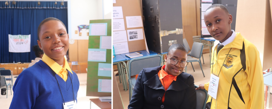 Learners standing in front of their posters