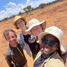 Selfie of smiling NamTip researchers with savanna rangeland in the background