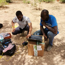 The PhD student from Ghana is showing one PhD student from Burkina the data logging equipment