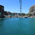 Dammed Rhone near Genf, stream up, view of city in background