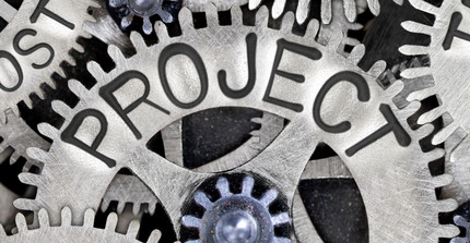 Gears engraved with project-related terms mesh together Gears engraved with project-related terms mesh together