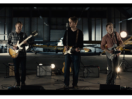 Drei Musiker mit Gitarren