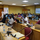 Project members and stakeholders seated in the conference room
