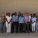 Group picture of NamTip researchers in front of neutral background