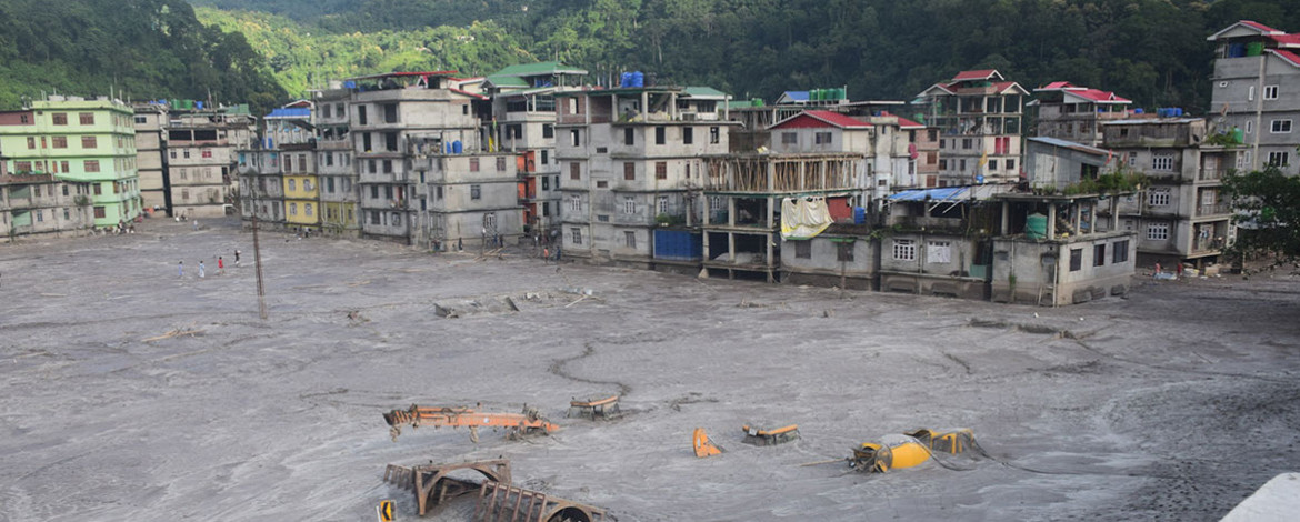 Buildings and cars in the town of Rangpo were buried under the sediment masses of the flood. - 