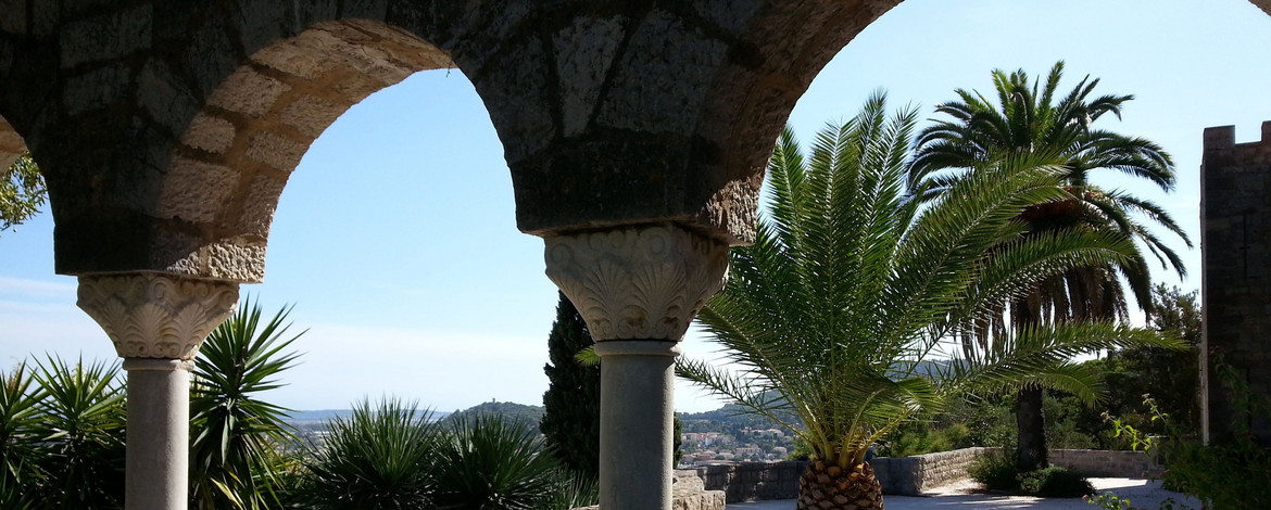 Blick auf einen mediterranen Garten mit Palme und Meerblick in Hyères-les-Palmiers (Côte d'Azur) - 